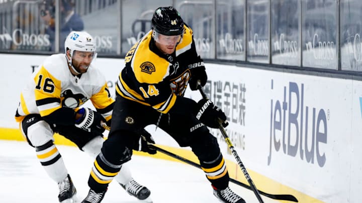 BOSTON, MASSACHUSETTS - JANUARY 28: Jason Zucker #16 of the Pittsburgh Penguins defends Chris Wagner #14 of the Boston Bruins during the second period at TD Garden on January 28, 2021 in Boston, Massachusetts. (Photo by Maddie Meyer/Getty Images)