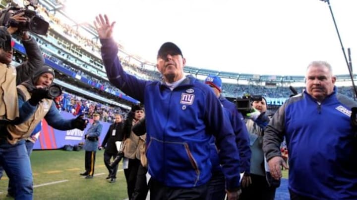 Jan 3, 2016; East Rutherford, NJ, USA; New York Giants head coach Tom Coughlin (C) waves to fans while walking off the field after the game against the Philadelphia Eagles at MetLife Stadium. The Eagles won 35-30. Mandatory Credit: Brad Penner-USA TODAY Sports