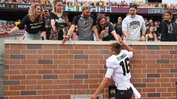 Oct 1, 2022; Minneapolis, Minnesota, USA; Purdue Boilermakers quarterback Aidan O’Connell (16) celebrates the win with fans against the Minnesota Golden Gophers after the game at Huntington Bank Stadium. Mandatory Credit: Matt Krohn-USA TODAY Sports
