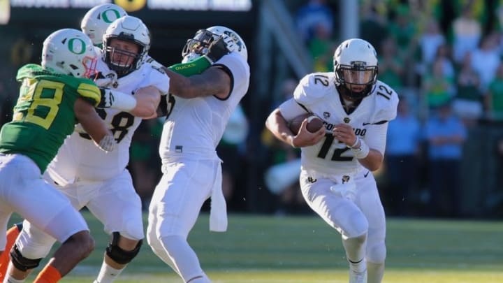 Sep 24, 2016; Eugene, OR, USA; Colorado Buffaloes offensive lineman Gerrad Kough (68) blocks Oregon Ducks linebacker Johnny Ragin III (28) as Colorado Buffaloes quarterback Steven Montez (12) runs the ball in the second half at Autzen Stadium. Mandatory Credit: Scott Olmos-USA TODAY Sports