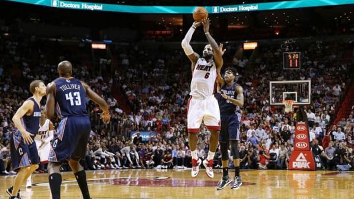 Mar 3, 2014; Miami, FL, USA; Miami Heat small forward LeBron James (6) shoots a three point shot in front of Charlotte Bobcats shooting guard Chris Douglas-Roberts (55) in the second half at American Airlines Arena. The Heat won 124-107. Mandatory Credit: Robert Mayer-USA TODAY Sports