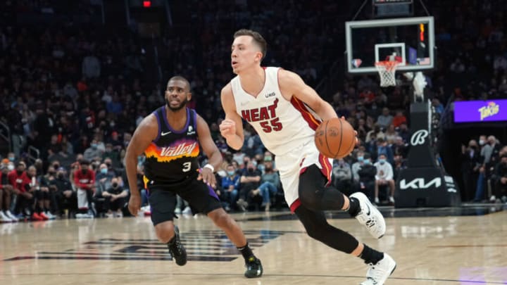 Miami Heat guard Duncan Robinson (55) dribbles against Phoenix Suns guard Chris Paul (3)(Joe Camporeale-USA TODAY Sports)