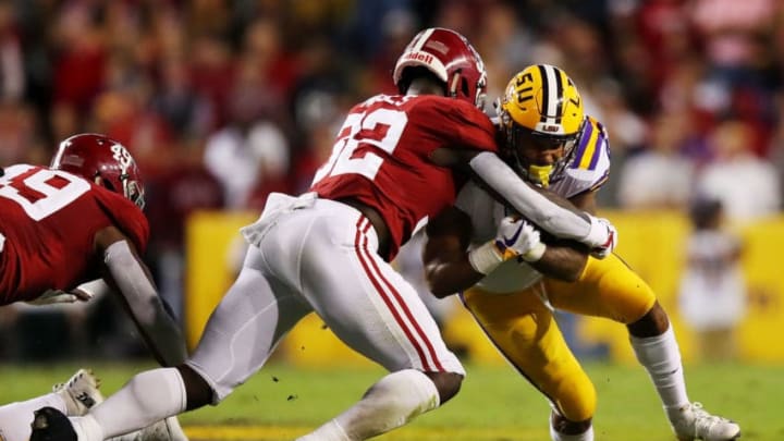 BATON ROUGE, LOUISIANA - NOVEMBER 03: Nick Brossette #4 of the LSU Tigers tries to avoid the tackle of Dylan Moses #32 of the Alabama Crimson Tide in the first half of their game at Tiger Stadium on November 03, 2018 in Baton Rouge, Louisiana. (Photo by Gregory Shamus/Getty Images)
