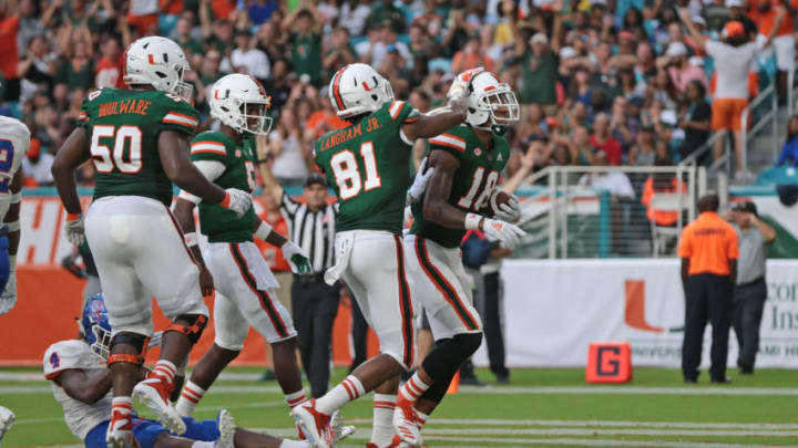 MIAMI GARDENS, FL - SEPTEMBER 8: Lawrence Cager #18 is congratulated by Darrell Langham #81 of the Miami Hurricanes after scoring a second quarter touchdown against the Savannah State Tigers on September 8, 2018 at Hard Rock Stadium in Miami Gardens, Florida.(Photo by Joel Auerbach/Getty Images)