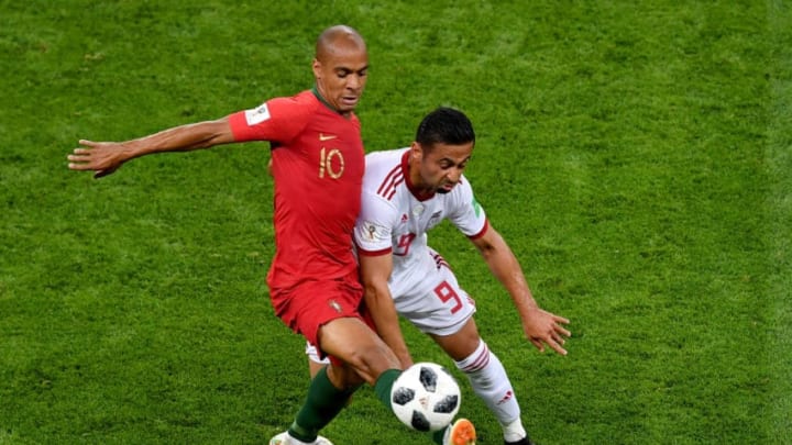 SARANSK, RUSSIA – JUNE 25: Omid Ebrahimi of Iran challenge for the ball with Joao Mario of Portugal during the 2018 FIFA World Cup Russia group B match between Iran and Portugal at Mordovia Arena on June 25, 2018 in Saransk, Russia. (Photo by Hector Vivas/Getty Images)