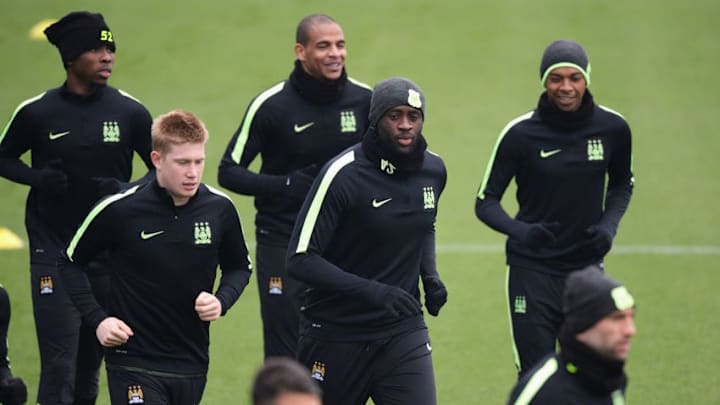 MANCHESTER, ENGLAND - APRIL 11: Kevin de Bruyne and Yaya Toure of Manchester City warm up with team mates during a training session ahead of the UEFA Champions League Quarter Final Second Leg match against Paris Saint-Germain at the Academy training ground on April 11, 2016 in Manchester, United Kingdom. (Photo by Gareth Copley/Getty Images)