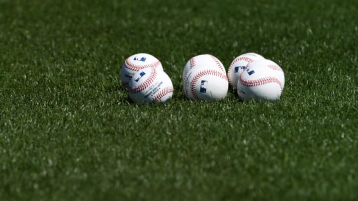 GOODYEAR, ARIZONA - MARCH 14: A detail view of several baseballs on the outfield grass prior to a spring training game between the Cincinnati Reds and San Diego Padres at Goodyear Ballpark on March 14, 2021 in Goodyear, Arizona. (Photo by Norm Hall/Getty Images)