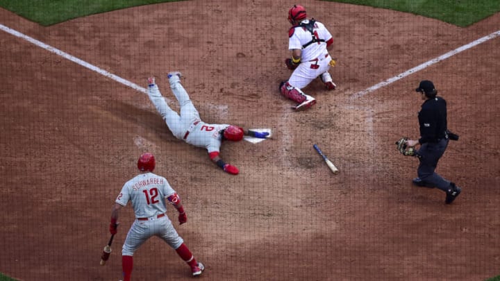 Oct 7, 2022; St. Louis, Missouri, USA; Philadelphia Phillies second baseman Jean Segura (2) slides safely past St. Louis Cardinals catcher Yadier Molina (4) in the ninth inning during game one of the Wild Card series for the 2022 MLB Playoffs at Busch Stadium. Mandatory Credit: Jeff Curry-USA TODAY Sports