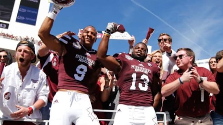 Oct 4, 2014; Starkville, MS, USA; Mississippi State Bulldogs defensive back Justin Cox (9) and Mississippi State Bulldogs running back Josh Robinson (13) celebrate their teams win against the Texas A&M Aggies at Davis Wade Stadium. The Bulldogs defeated the Aggies 48-31. Mandatory Credit: Marvin Gentry-USA TODAY Sports