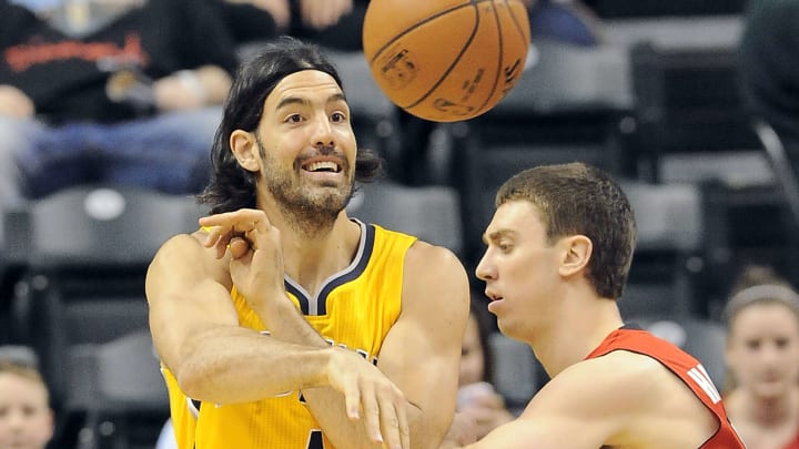 Mar 16, 2015; Indianapolis, IN, USA; Indiana Pacers forward Luis Scola (4) passes against Toronto Raptors forward Tyler Hansborough (50) at Bankers Life Fieldhouse. Mandatory Credit: Thomas J. Russo-USA TODAY Sports