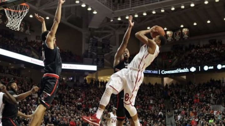 Feb 17, 2016; Lubbock, TX, USA; Oklahoma Sooners guard Isaiah Cousins (11) tries to shoot between Texas Tech Red Raiders guard Toddrick Gotcher (20) and forward Zach Smith (11) in the second half at United Supermarkets Arena. Texas Tech defeated Oklahoma 65-63. Mandatory Credit: Michael C. Johnson-USA TODAY Sports