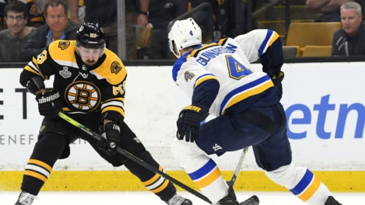 BOSTON, MASSACHUSETTS - JUNE 12: Brad Marchand #63 of the Boston Bruins looks to make a play with the puck against Carl Gunnarsson #4 of the St. Louis Blues during the second period of the 2019 NHL Stanley Cup Final at TD Garden on June 12, 2019 in Boston, Massachusetts. (Photo by Scott Rovak/NHLI via Getty Images)
