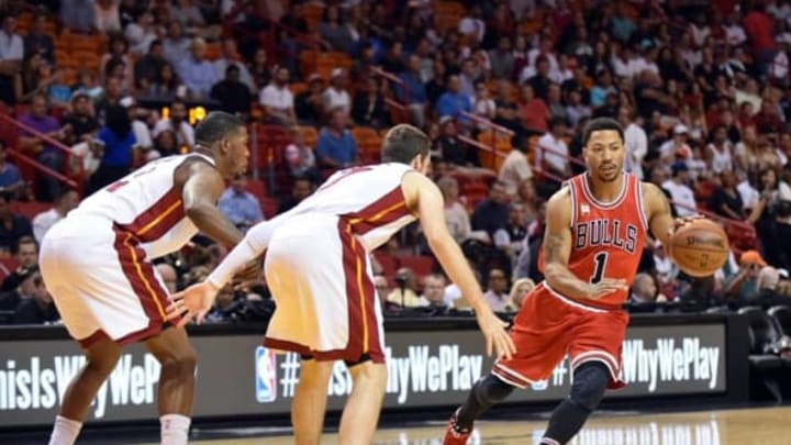 Apr 7, 2016; Miami, FL, USA; Chicago Bulls guard Derrick Rose (1) dribbles the ball as Miami Heat guard Goran Dragic (7) defends during the first half at American Airlines Arena. Mandatory Credit: Steve Mitchell-USA TODAY Sports