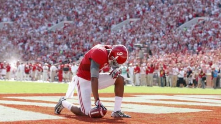 Sep 20, 2014; Tuscaloosa, AL, USA; Alabama Crimson Tide wide receiver Amari Cooper (9) takes a moment after scoring a touchdown against the Florida Gators at Bryant-Denny Stadium. Mandatory Credit: Marvin Gentry-USA TODAY Sports