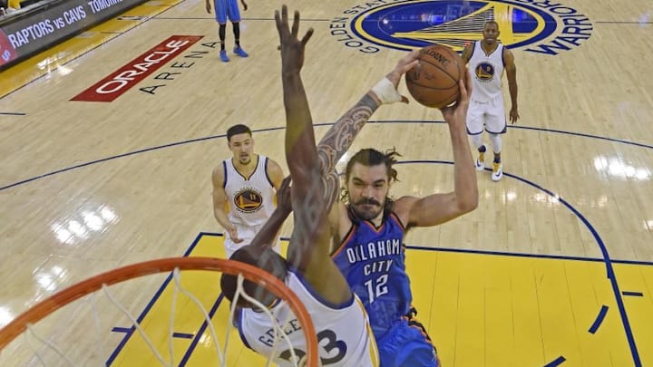 May 16, 2016; Oakland, CA, USA; Oklahoma City Thunder center Steven Adams (12) goes up for a dunk against Golden State Warriors forward Draymond Green (23) in the fourth quarter in game one of the Western conference finals of the NBA Playoffs at Oracle Arena. The Thunder defeated the Warriors 108-102. Mandatory Credit: Jose Carlos Fajardo-Pool Photo via USA TODAY Sports