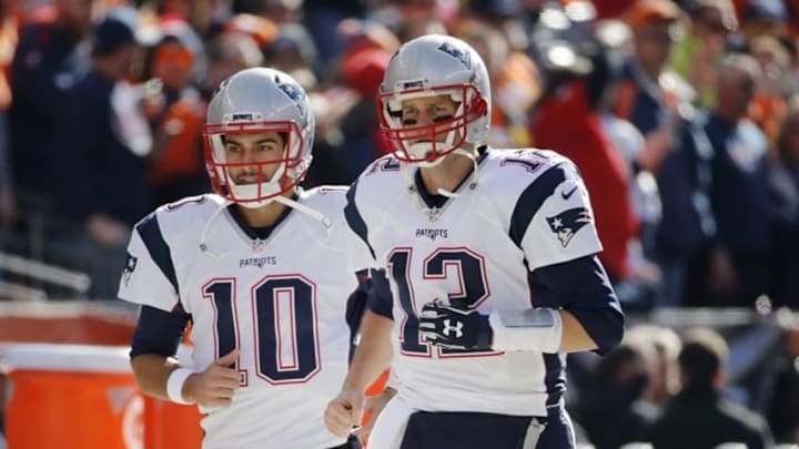 Jan 24, 2016; Denver, CO, USA; New England Patriots quarterback Tom Brady (12) and quarterback Jimmy Garoppolo (10) take the field before the AFC Championship football game against the Denver Broncos at Sports Authority Field at Mile High. Mandatory Credit: Kevin Jairaj-USA TODAY Sports