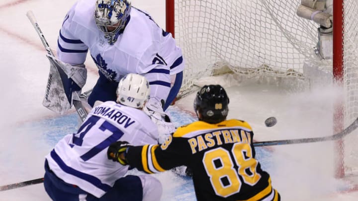 BOSTON, MA - APRIL 12: Toronto Maple Leafs goaltender Frederik Andersen can't stop Boston Bruins player Brad Marchand, not pictured, goal in the first period as Bruins David Pastrnak moves in with Toronto's Leo Komarov in Game One of the Eastern Conference First Round during the 2018 NHL Stanley Cup Playoffs at TD Garden in Boston on April 12, 2018. (Photo by John Tlumacki/The Boston Globe via Getty Images)