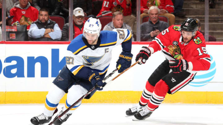 CHICAGO, IL - NOVEMBER 14: Alex Pietrangelo #27 of the St. Louis Blues grabs the puck ahead of Artem Anisimov #15 of the Chicago Blackhawks in the second period at the United Center on November 14, 2018 in Chicago, Illinois. (Photo by Chase Agnello-Dean/NHLI via Getty Images)