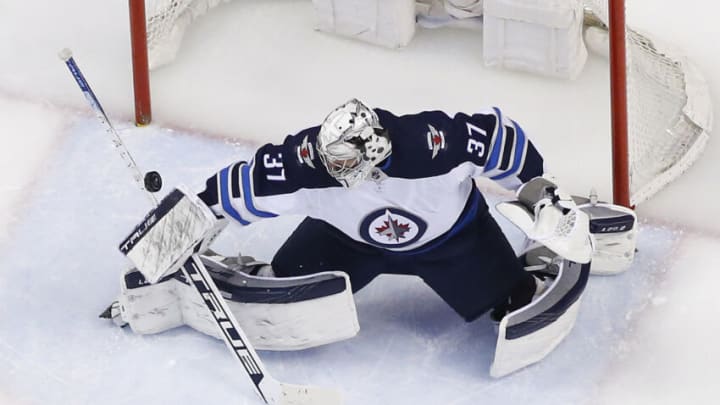 SUNRISE, FL - APRIL 15: Goaltender Connor Hellebuyck #37 of the Winnipeg Jets stops a shot by Maxim Mamin #98 of the Florida Panthers at the FLA Live Arena on April 15, 2022 in Sunrise, Florida. (Photo by Joel Auerbach/Getty Images)