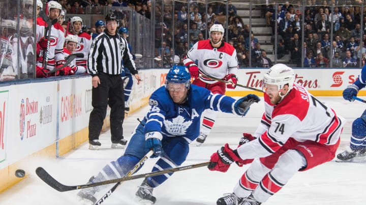 TORONTO, ON – OCTOBER 26: Morgan Rielly #44 of the Toronto Maple Leafs battles past Jaccob Slavin #74 of the Carolina Hurricanes during the first period at the Air Canada Centre on October 26, 2017 in Toronto, Ontario, Canada. (Photo by Mark Blinch/NHLI via Getty Images)