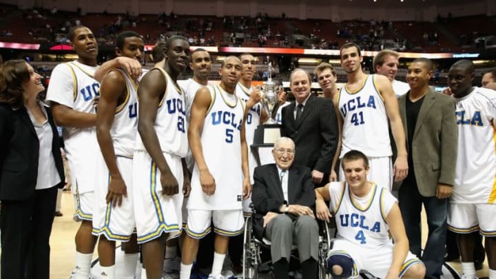 ANAHEIM, CA - DECEMBER 13: Former coach John Wooden poses together with the UCLA Bruins team, head coach Ben Howland and great grandson Tyler Trapani #4 after the John R. Wooden Classic game against the DePaul Blue Demons at Honda Center on December 13, 2008 in Anaheim, California. The Bruins defeated the Blue Demons 72-54. (Photo by Christian Petersen/Getty Images)