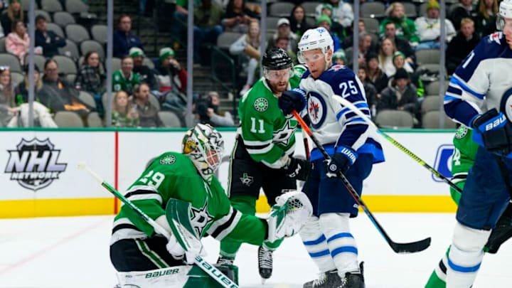 Feb 23, 2022; Dallas, Texas, USA; Dallas Stars goaltender Jake Oettinger (29) makes a glove save in front of Winnipeg Jets center Paul Stastny (25) during the first period at the American Airlines Center. Mandatory Credit: Jerome Miron-USA TODAY Sports