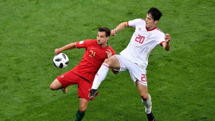 SARANSK, RUSSIA - JUNE 25: Sardar Azmoun of Iran tackles Cedric of Portugal during the 2018 FIFA World Cup Russia group B match between Iran and Portugal at Mordovia Arena on June 25, 2018 in Saransk, Russia. (Photo by Hector Vivas/Getty Images)