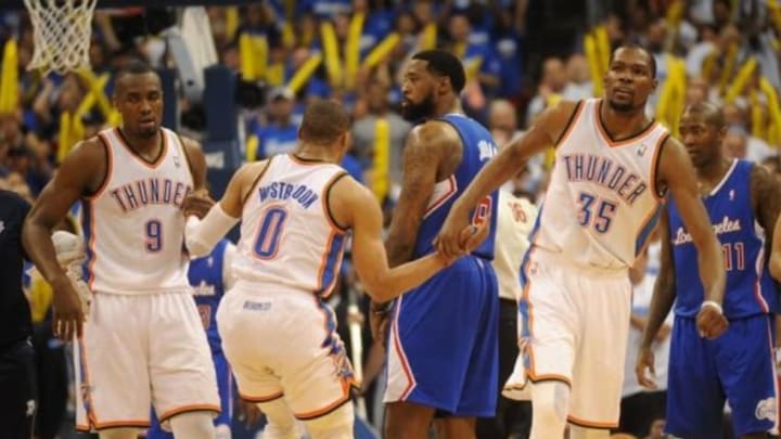 May 7, 2014; Oklahoma City, OK, USA; Oklahoma City Thunder guard Russell Westbrook (0) is helped off of the court floor by Oklahoma City Thunder forward Kevin Durant (35) and Oklahoma City Thunder forward Serge Ibaka (9) after being fouled in action against the Los Angeles Clippers in game two of the second round of the 2014 NBA Playoffs at Chesapeake Energy Arena. Mandatory Credit: Mark D. Smith-USA TODAY Sports
