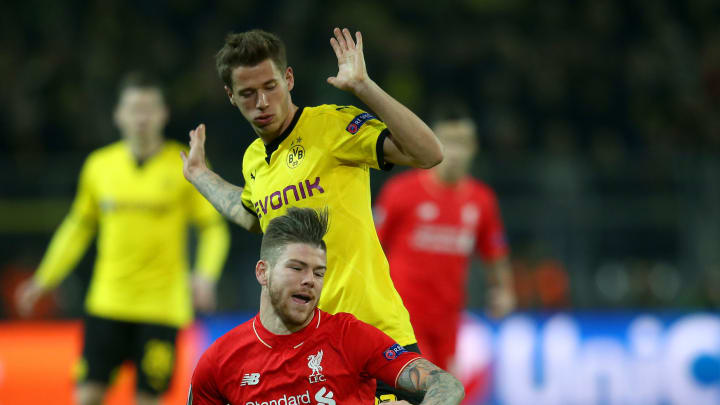 DORTMUND, GERMANY – APRIL 07: Alberto Moreno of Liverpool is challenged by Eric Durm of Borussia Dortmund during the UEFA Europa League quarter final first leg match between Borussia Dortmund and Liverpool at Signal Iduna Park on April 7, 2016 in Dortmund, Germany. (Photo by Lars Baron/Bongarts/Getty Images)