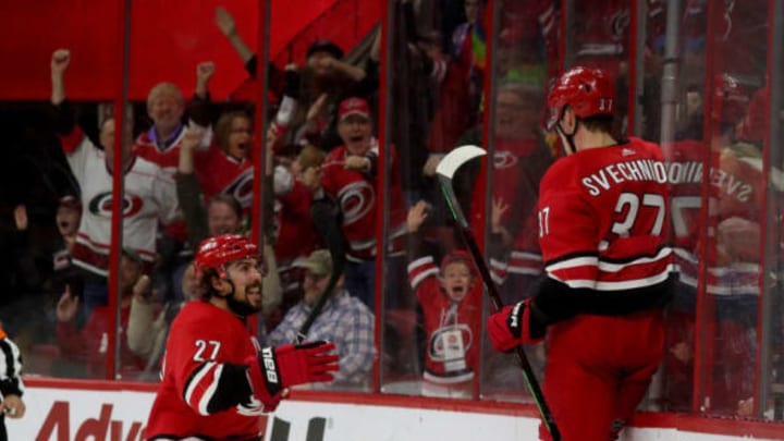 RALEIGH, NC – MARCH 24: Andrei Svechnikov #37 of the Carolina Hurricanes scores the game winning goal in overtime and celebrates with teammate Justin Faulk #27 during an NHL game against the Montreal Canadiens March 24, 2019 at PNC Arena in aleigh, North Carolina. (Photo by Gregg Forwerck/NHLI via Getty Images)