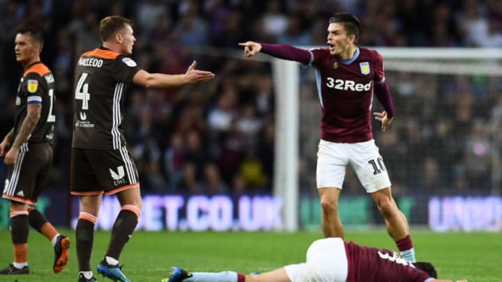 BIRMINGHAM, ENGLAND - AUGUST 22: Jack Grealish of Aston Villa and Lewis Macleod of Brentford reacts over a foul during the Sky Bet Championship match between Aston Villa and Brentford at Villa Park on August 22, 2018 in Birmingham, England. (Photo by Clive Mason/Getty Images)