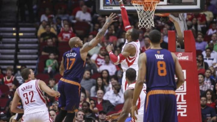 Dec 4, 2013; Houston, TX, USA; Houston Rockets power forward Dwight Howard (12) attempts to block a shot by Phoenix Suns small forward P.J. Tucker (17) during the second quarter at Toyota Center. Mandatory Credit: Troy Taormina-USA TODAY Sports
