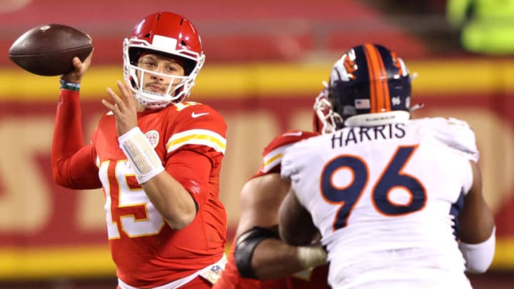 KANSAS CITY, MISSOURI - DECEMBER 06: Patrick Mahomes #15 of the Kansas City Chiefs looks to pass over defender Shelby Harris #96 of the Denver Broncos during the fourth quarter of a game at Arrowhead Stadium on December 06, 2020 in Kansas City, Missouri. (Photo by Jamie Squire/Getty Images)
