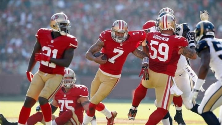 Dec 1, 2013; San Francisco, CA, USA; San Francisco 49ers quarterback Colin Kaepernick (7) is unable to break free from the hold of St. Louis Rams defensive tackle Jermelle Cudjo (93) in the first quarter at Candlestick Park. Mandatory Credit: Cary Edmondson-USA TODAY Sports