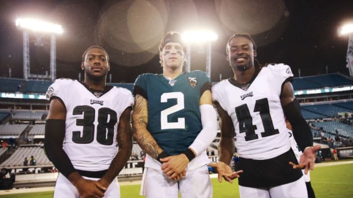 JACKSONVILLE, FLORIDA - AUGUST 15: Quarterback Alex McGough #2 of the Jacksonville Jaguars poses with Jeremiah McKinnon #38 and Johnathan Cyprien #41 of the Philadelphia Eagles after the game at TIAA Bank Field on August 15, 2019 in Jacksonville, Florida. (Photo by Harry Aaron/Getty Images)