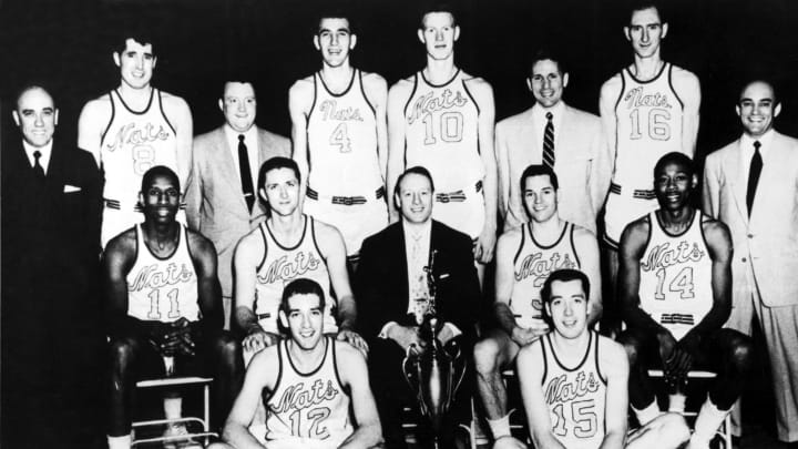 SYRACUSE – NEW YORK 1955: The World Champions of basketball Syracuse Nationals pose for a team portrait front row (L-R): Dick Farley, Billy Kenville, Center Row: Earl Lloyd, Captain Paul Seymour, Head Coach Al Cervi, George King Jim Tucker, Rear Row: President Daniel Biasone, Wally Osterkorn, Business Manager Bob Sexton, Dolph Schayes, John Kerr, Billy Gabor Red rocha, Trainer Art Van Auken in Syracuse, New York in 1955. NOTE TO USER: User expressly acknowledges and agrees that, by downloading and or using this photograph, User is consenting to the terms and conditions of the Getty Images License Agreement. Mandatory copyright notice: Copyright NBAE 1955 (Photo by The Stevenson Collection/NBAE/Getty Images)