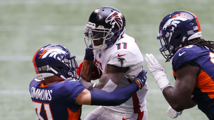 ATLANTA, GEORGIA – NOVEMBER 08: Justin Simmons #31 of the Denver Broncos tackles Julio Jones #11 of the Atlanta Falcons during the first half at Mercedes-Benz Stadium on November 08, 2020 in Atlanta, Georgia. (Photo by Kevin C. Cox/Getty Images)