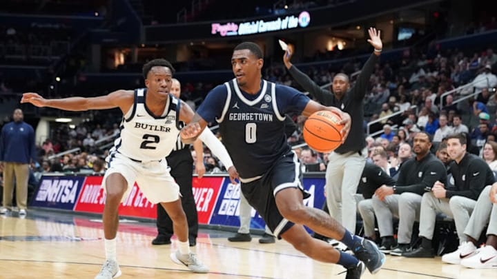 WASHINGTON, DC - JANUARY 01: Brandon Murray #0 of the Georgetown Hoyas dribbles by Eric Hunter Jr. #2 of the Butler Bulldogs in the first half during a college basketball game at the Capital One Arena on January 1, 2023 in Washington, DC. (Photo by Mitchell Layton/Getty Images)