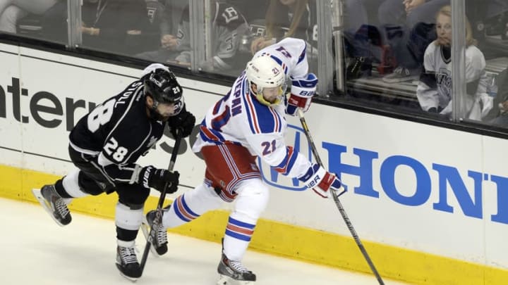 Jun 13, 2014; Los Angeles, CA, USA; New York Rangers center Derek Stepan (21) battles for the puck with Los Angeles Kings center Jarret Stoll (28) during the first period in game five of the 2014 Stanley Cup Final at Staples Center. Mandatory Credit: Richard Mackson-USA TODAY Sports