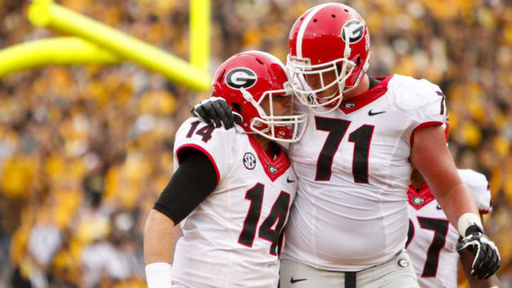 COLUMBIA, MO - OCTOBER 11: Hutson Mason #14 celebrates with John Theus #71 of the Georgia Bulldogs after Hutson Mason scored the first touchdown of the game to put the bulldogs up 13 to o against the Missouri Tigers on October 11, 2014 at Faurot Field/Memorial Stadium in Columbia, Missouri. (Photo by Kyle Rivas/Getty Images)