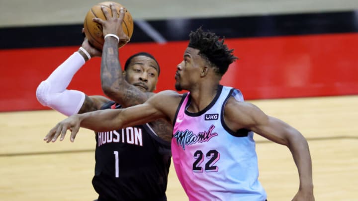 John Wall #1 of the Houston Rockets controls the ball against Jimmy Butler #22 of the Miami Heat (Photo by Carmen Mandato/Getty Images)