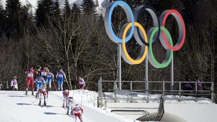 Feb 8, 2014; Krasnaya Polyana, RUSSIA; Athletes ski past the Olympic rings during the Sochi 2014 Olympic Winter Games at Laura Cross-Country Ski and Biathlon Center. Mandatory Credit: Eric Bolte-USA TODAY Sports
