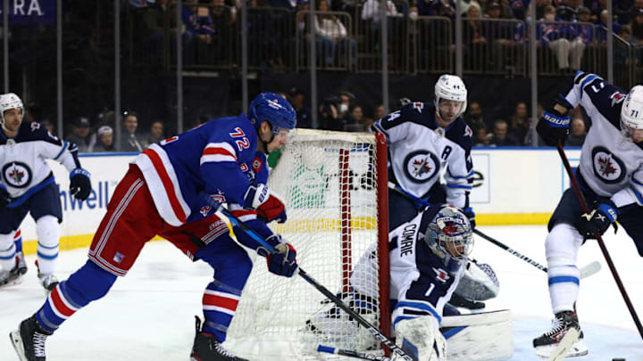 NEW YORK, NEW YORK - APRIL 19: Filip Chytil #72 of the New York Rangers wraps around the net as Eric Comrie #1 of the Winnipeg Jets makes the save during the second period at Madison Square Garden on April 19, 2022 in New York City. (Photo by Elsa/Getty Images)