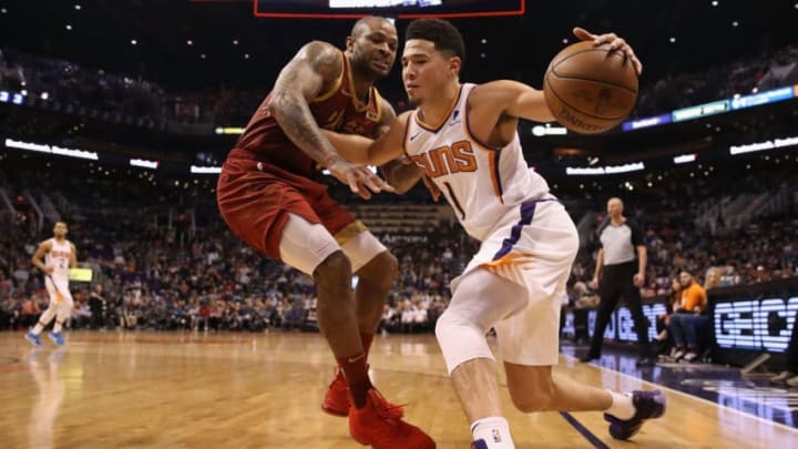 PHOENIX, ARIZONA - FEBRUARY 04: Devin Booker #1 of the Phoenix Suns handles the ball under pressure from PJ Tucker #17 of the Houston Rockets during the second half of the NBA game at Talking Stick Resort Arena on February 04, 2019 in Phoenix, Arizona. The Rockets defeated the Suns 118-110. (Photo by Christian Petersen/Getty Images)
