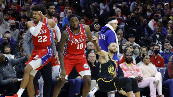 PHILADELPHIA, PENNSYLVANIA - DECEMBER 11: Matisse Thybulle #22, Shake Milton #18 and Seth Curry #31 of the Philadelphia 76ers react as Stephen Curry #30 of the Golden State Warriors shoots a three pointer at Wells Fargo Center on December 11, 2021 in Philadelphia, Pennsylvania. NOTE TO USER: User expressly acknowledges and agrees that, by downloading and or using this photograph, User is consenting to the terms and conditions of the Getty Images License Agreement. (Photo by Tim Nwachukwu/Getty Images)