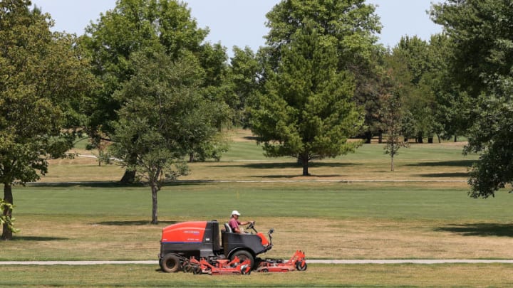 GRANGER, IA - AUGUST 07: A worker drives a mower over brown grass at Jester Park Golf Course on August 7, 2012 in Granger, Iowa. An exceptionally hot summer and the worst drought in more than a half century has caused cut prospects for the U.S. corn crop to a five-year low and has sent prices up to over $8.00 a bushel in late July trading. The price surge and limited supply has also prompted ethanol plants to voluntarily slow production by 20 percent, a two year low. (Photo by Justin Sullivan/Getty Images)