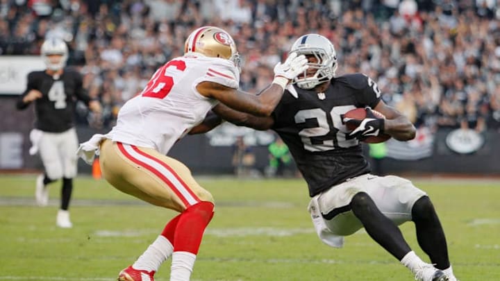 OAKLAND, CA – DECEMBER 7: Running back Latavius Murray #28 of the Oakland Raiders picks up 16 yards to the 10-yard line before being stopped by defensive back Dontae Johnson #36 of the San Francisco 49ers in the fourth quarter on December 7, 2014 at O.co Coliseum in Oakland, California. The Raiders won 24-13. (Photo by Brian Bahr/Getty Images)