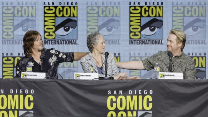 SAN DIEGO, CALIFORNIA - JULY 22: (L-R) Norman Reedus, Melissa McBride, and Josh McDermitt speak onstage at AMC's "The Walking Dead" panel during 2022 Comic-Con International: San Diego at San Diego Convention Center on July 22, 2022 in San Diego, California. (Photo by Kevin Winter/Getty Images)