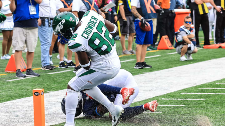 Oct 3, 2021; East Rutherford, New Jersey, USA; New York Jets wide receiver Jamison Crowder (82) catches a touchdown pass in front of Tennessee Titans cornerback Kristian Fulton (26) during the second half at MetLife Stadium. Mandatory Credit: Vincent Carchietta-USA TODAY Sports
