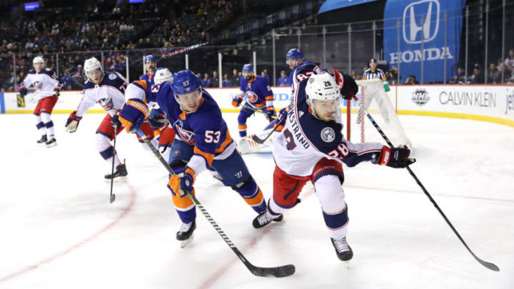 NEW YORK, NY - FEBRUARY 13: Casey Cizikas #53 of the New York Islanders and Oliver Bjorkstrand #28 of the Columbus Blue Jackets chase after the puck in the first period during their game at Barclays Center on February 13, 2018 in the Brooklyn borough of New York City. (Photo by Abbie Parr/Getty Images)